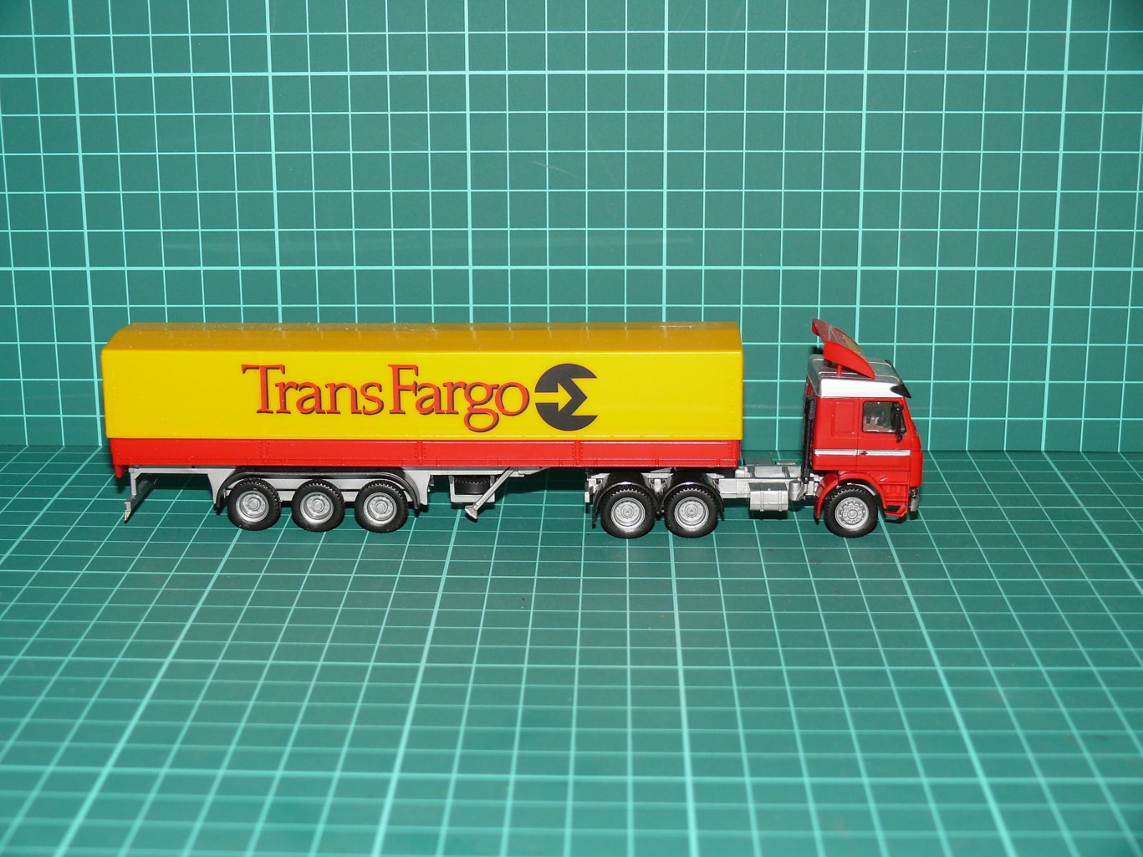 Roco H0 – Tahač návěsů Scania 143M 3-osý s plachtovým návěsem „TransFargo“ – H0